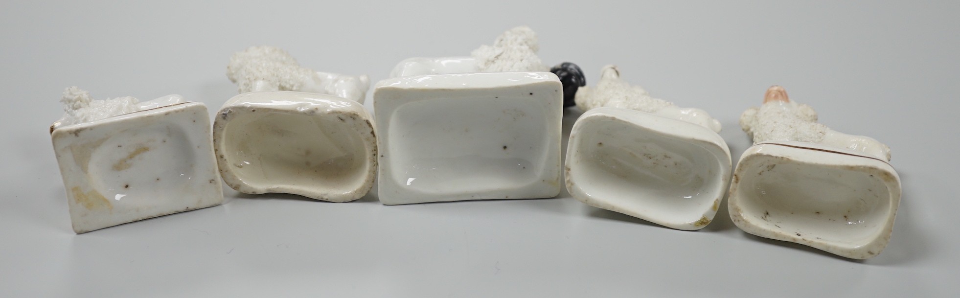 Five small Staffordshire models of poodles standing on their bases, to include a Lloyd Shelton white poodle with black muzzle, and a Lloyd Shelton white poodle with flicked tail (5), c.1830-50. Tallest 6cm, Cf. Dennis G.